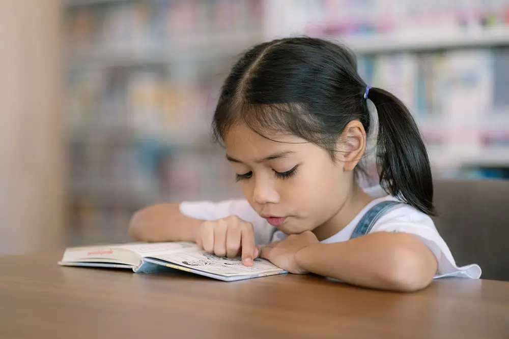 asian girl reading at desk